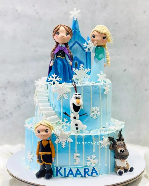 This Frozen-themed cake features all the main characters as detailed, edible figurines. I created a winter wonderland with a two-tiered structure, complete with a castle staircase and delicate snowflakes.