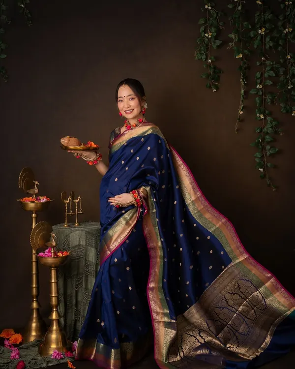 A modern goddess. Draped in a stunning blue silk saree, this mother-to-be holds a traditional plate of offerings. This is a beautiful fusion of cultural ritual and maternity celebration.