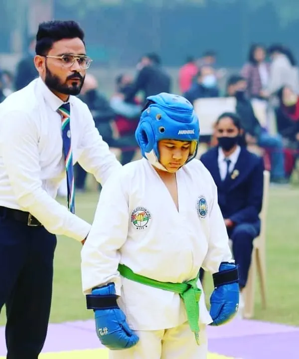 Coaching one of my students from the sidelines during a sparring match. My role is to guide them, keep them focused, and help them adapt their strategy in real-time.
