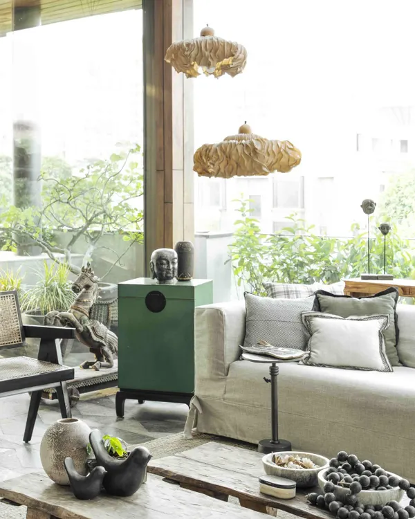 The conservatory, or sunroom, is rooted in a Wabi-Sabi aesthetic, embracing imperfection and natural elements. The space features a rustic coffee table from Nagaland and a striking horse sculpture from Jew Town, Kochi.
