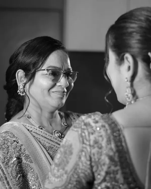 A mother's love, a lifetime in a glance. This over-the-shoulder shot captures the pride and emotion in a mother's eyes as she looks at her daughter, the bride.