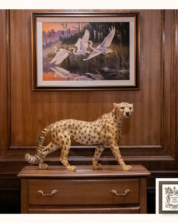 This handcrafted cheetah sculpture, set against a rich wood-paneled wall, is a bold statement of art and elegance. It adds character and a story to your space, blending classic style with a touch of the wild.