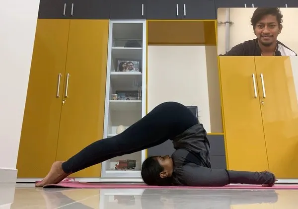 This is a snapshot of an online class where I guide a student through Halasana. Even through a screen, I can provide corrections and encouragement to help you perfect your form.
