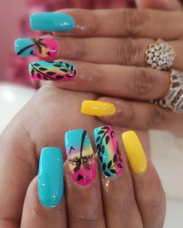 This vibrant, hand-painted tropical beach scene on long square extensions shows the level of detail I love to create. It combines a sunset gradient, silhouette palm trees, and leafy patterns for the perfect vacation-ready manicure.