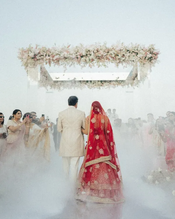 A bride's magical walk towards her forever. We created this dreamy aisle with ethereal smoke, leading to a floating mandap against the sea in Oman, turning a simple walk into a cinematic moment.