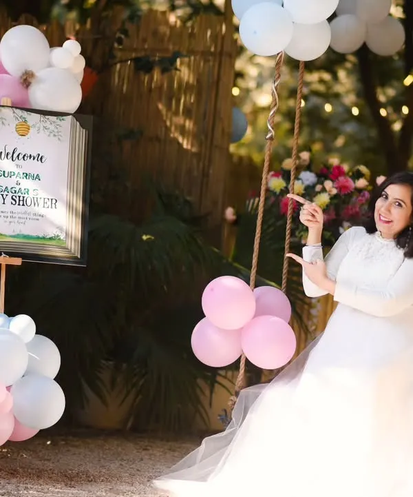 We can create a full baby shower theme for your photoshoot. This setup includes a welcome sign and festive balloons, making it a perfect way to celebrate and announce your joy.