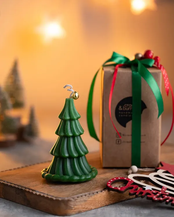My classic green Christmas tree candle, complete with a tiny jingle bell on top. It comes ready for gifting in a lovely box with a festive green ribbon.