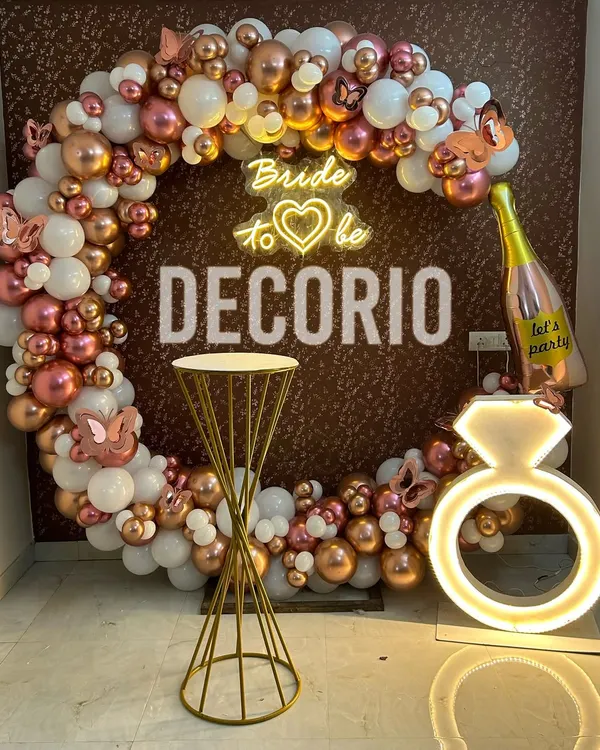 This rose gold bachelorette party setup is a perfect example of a modern and fun celebration. I combined a full circle balloon arch with a custom 'Bride to be' neon sign and fun props like the light-up ring and champagne bottle balloon to create a complete photo-ready corner.
