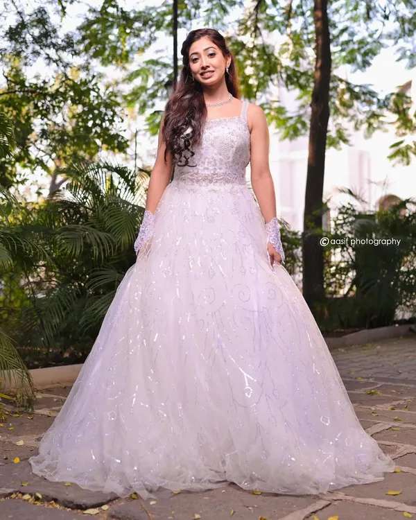 Feel like royalty in this stunning white ball gown. The full, sparkling skirt and detailed bodice create a breathtaking silhouette, perfect for a grand entrance or a fairytale photoshoot.