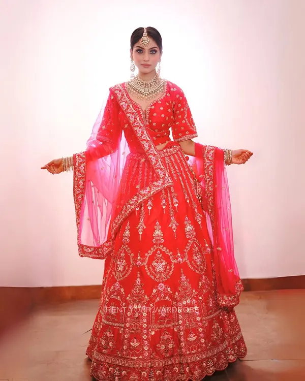 A full view of this gorgeous pink bridal lehenga. The intricate embroidery and matching dupatta make it a perfect choice for creating a classic bridal look for your makeup portfolio.