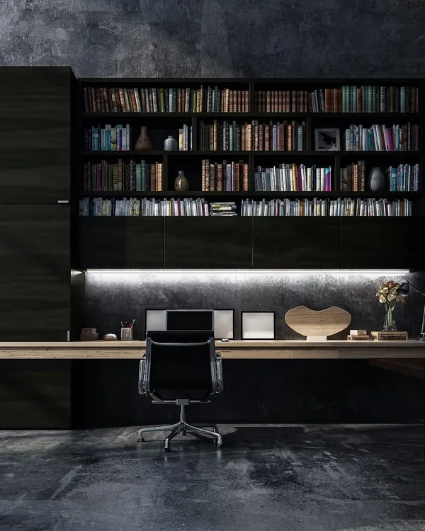 We designed this executive office to be both a productive workspace and a personal library. The design features custom dark wood cabinetry with integrated backlighting, a floating oak desk, and a textured concrete wall to create a sophisticated and moody atmosphere.