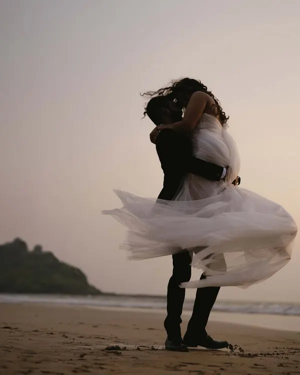 A windswept kiss on the shores of Goa, where the sea meets the sky. I believe pre-wedding shoots should feel this epic, capturing a moment of pure, uninhibited love that feels like the final scene of a beautiful film.