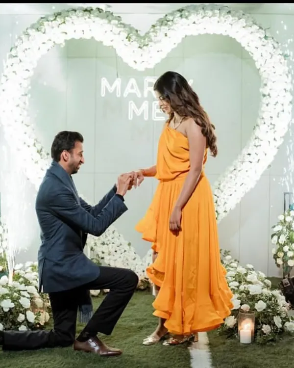 A picture perfect moment captured forever. We create stunning backdrops for proposals, complete with floral heart arches, custom neon signs, and dramatic cold pyro effects for that unforgettable "yes".