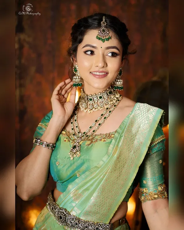 A full-length portrait of actress Samiksha styled in a stunning pastel green and gold lehenga. I managed the complete look, including the traditional jewelry and hair styling.