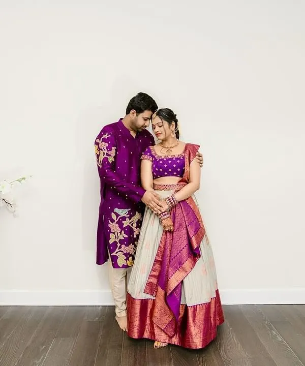 A beautiful moment between a couple, both dressed in bespoke Sindhu Reddy creations. The coordinated purple ensembles are perfect for their special day.