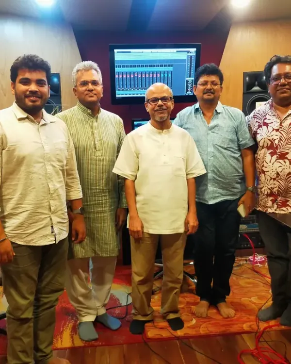 A happy moment in the studio after recording new original songs. This photo captures the team of composers, arrangers, and musicians involved in bringing a new piece of music to life.
