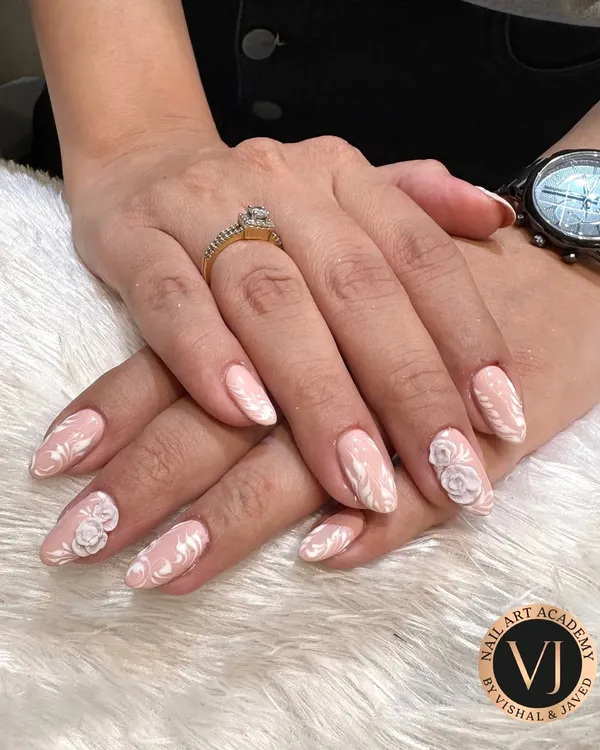 This is the kind of elegance and detail we love to create and teach. This design features a soft nude base with intricate, hand-painted white patterns and delicate 3D roses, perfect for bridal and high-fashion looks.
