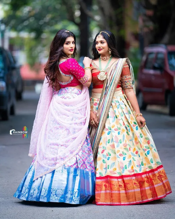 Two stunning and distinct Langa Voni styles available for rent. On the left, a modern printed silk, and on the right, a classic design with a leaf-patterned skirt.