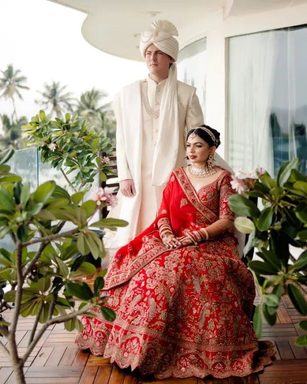 A regal portrait of the couple on a balcony overlooking the sea. We use natural surroundings to frame you, creating a timeless and elegant image that tells a story of romance.