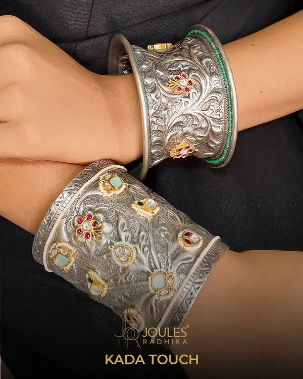 Oxidized beauty, handcrafted to perfection. This image showcases two of our statement kadas, featuring intricate floral carvings on oxidized silver, one accented with colorful stones.
