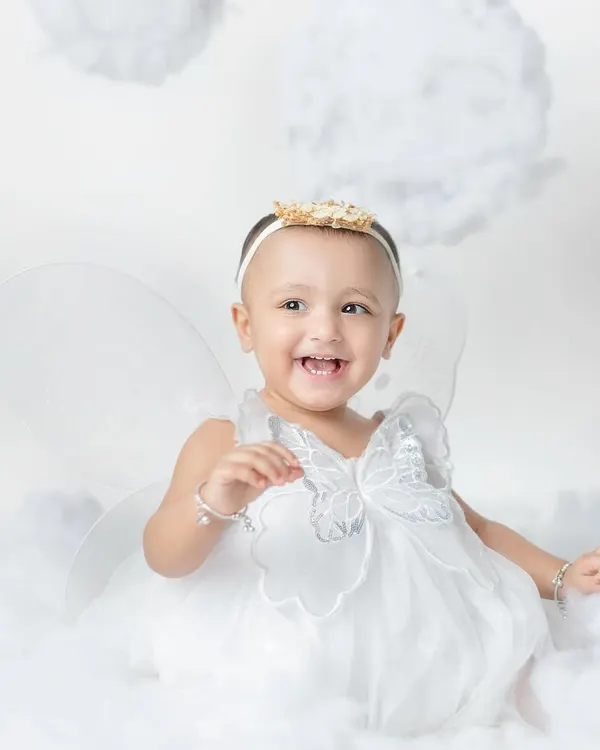 A little fairy with the sweetest laugh. My angel wing and cloud setup creates a dreamy, heavenly scene for your little one.