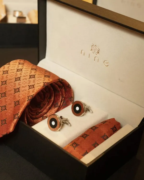 This is one of our most popular accessory gift sets, perfect for premium corporate gifting. It features a silk tie with a traditional motif, matching cufflinks, and a pocket square, all presented in our signature branded box.