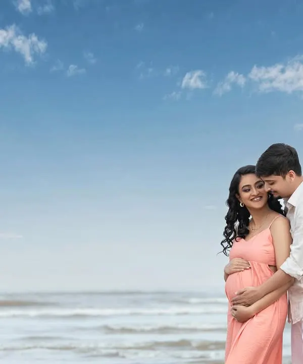 An intimate embrace on the beach, with the vast ocean behind them. This is a beautiful portrait of two people ready to start a new chapter together.
