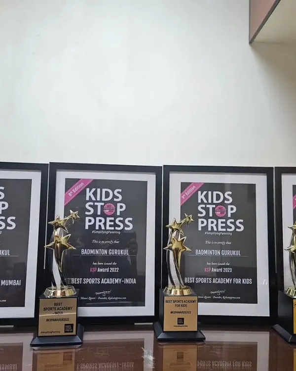 A display of our trophies and framed certificates from the Kids Stop Press Awards, where we were named Best Sports Academy in India.