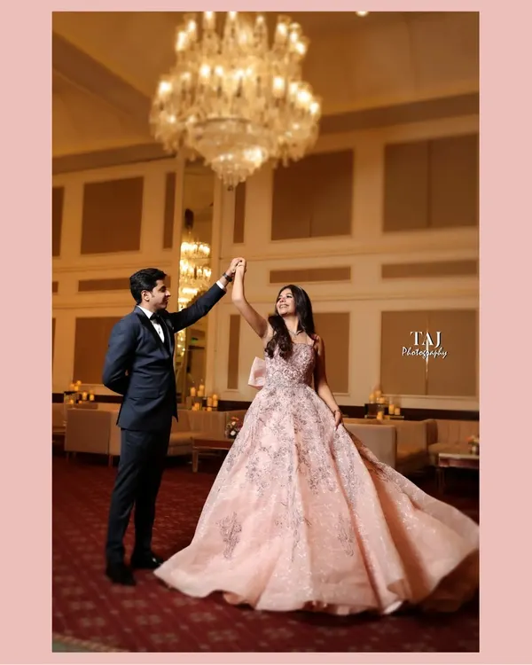 A fairytale dance under a magnificent crystal chandelier. The bride's flowing gown and the grand ballroom setting create a scene straight out of a romance novel. This is elegance personified.