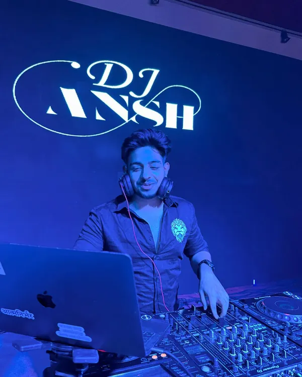 In my element behind the Pioneer DJ console, with my custom logo glowing in the background. This is my office, and I'm ready for the night.