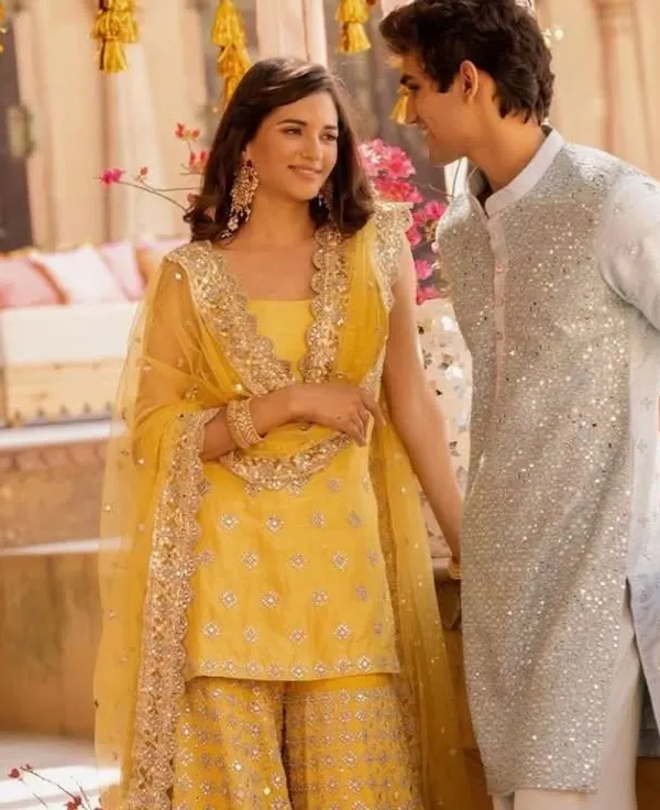 The elegance of a matching yellow sharara and sequined kurta is undeniable. If you love this festive look, I can create a similar custom-designed set for your Haldi or Mehendi.