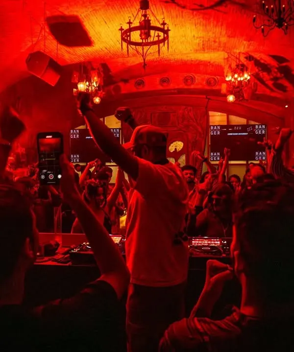 This is the moment of release. A packed club, bathed in red light, with every hand in the air. This shot from Banger Indore captures the raw, explosive energy of my peak-time techno sets.