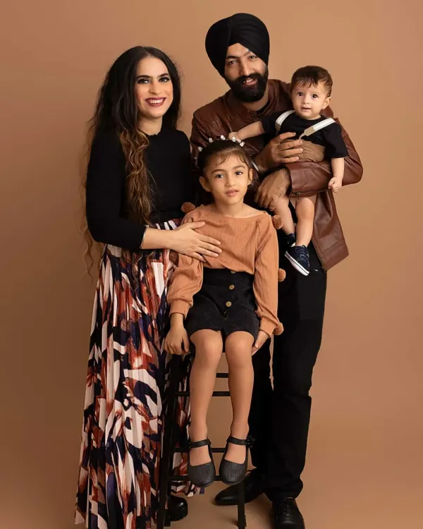 A beautiful family portrait showcasing coordinated earth-toned outfits. My studio provides a perfect neutral backdrop to make your family's connection the star of the show.