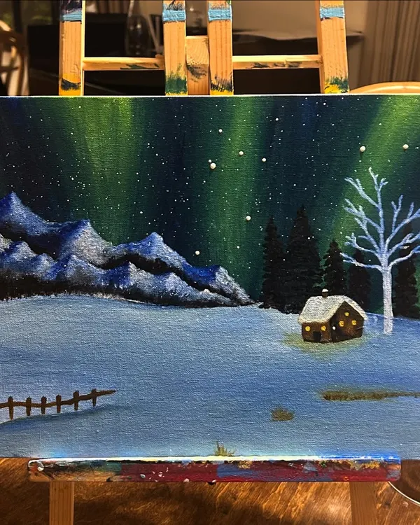 A beautiful Northern Lights painting on an easel. This is one of my most popular themes, and I'll show you how to blend the colors to create that magical glow.