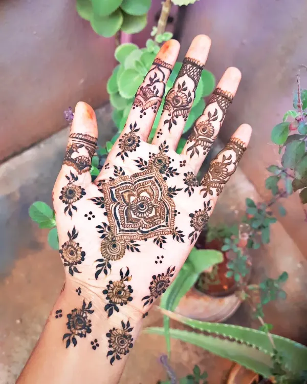 This is my signature party mehendi style. I love creating a central, intricate mandala on the palm and adding detailed patterns to the fingers for a full and festive look.