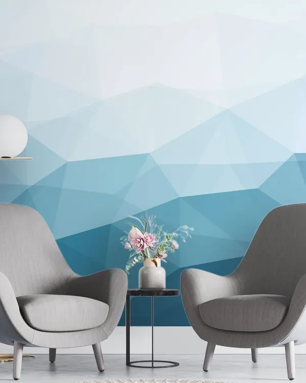 Our Blue Geometric Mural Wallpaper adds a cool and contemporary touch to this living room. The gradient of blues creates a calming and modern atmosphere.