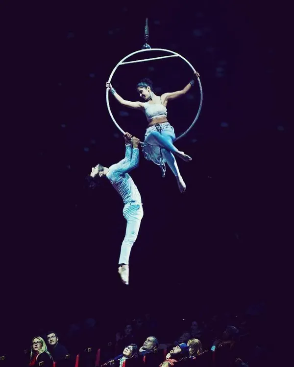 This is what it's all about: creating a moment of magic that an audience will never forget. A duo performance on the aerial hoop, or lyra, is a story of balance, trust, and connection, told high above the stage.