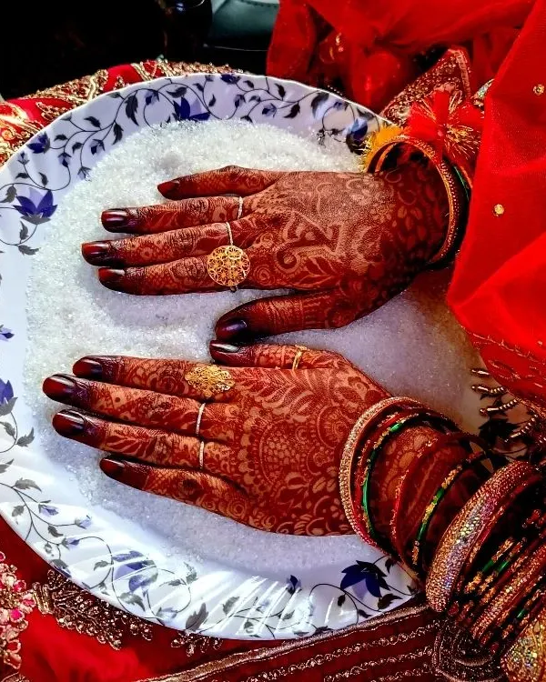 This is the moment every bride waits for. The deep, rich burgundy stain of my homemade organic henna, beautifully complementing the traditional bridal attire. It’s such a joy to see my art become a part of these sacred ceremonies.