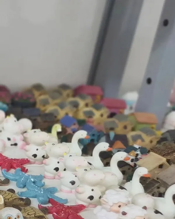 A collection of our miniature animal and house figurines. We have everything from tiny swans and sheep to little cottages, perfect for creating a fairy garden scene.