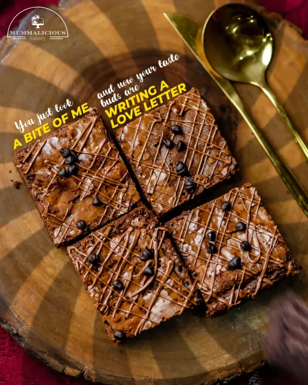 A love letter in brownie form. This overhead shot shows our classic chocolate chip brownies, perfectly cut and drizzled with more chocolate, ready to be devoured.
