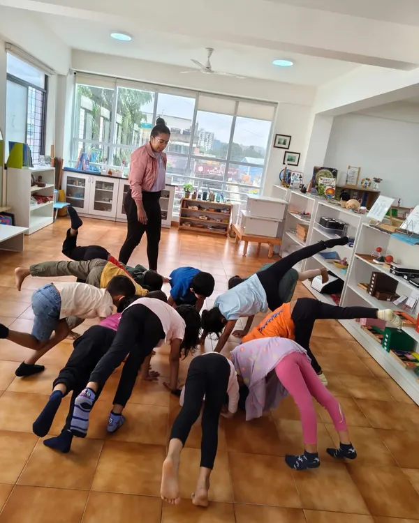 A dance and movement session in full swing. Children explore different ways their bodies can move, developing balance, coordination, and creative expression.