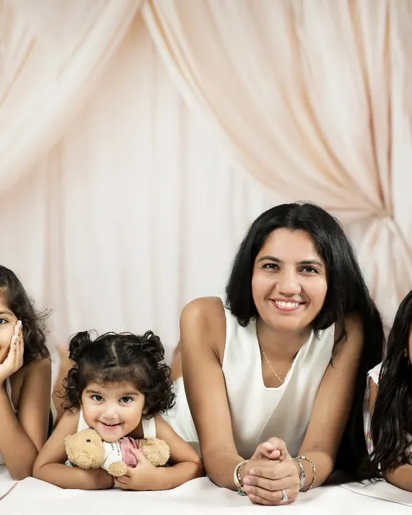 A mother and her three daughters, a beautiful gang of girls. This portrait, taken in our studio with a soft, neutral boho setup, captures the strong and loving bond they share.