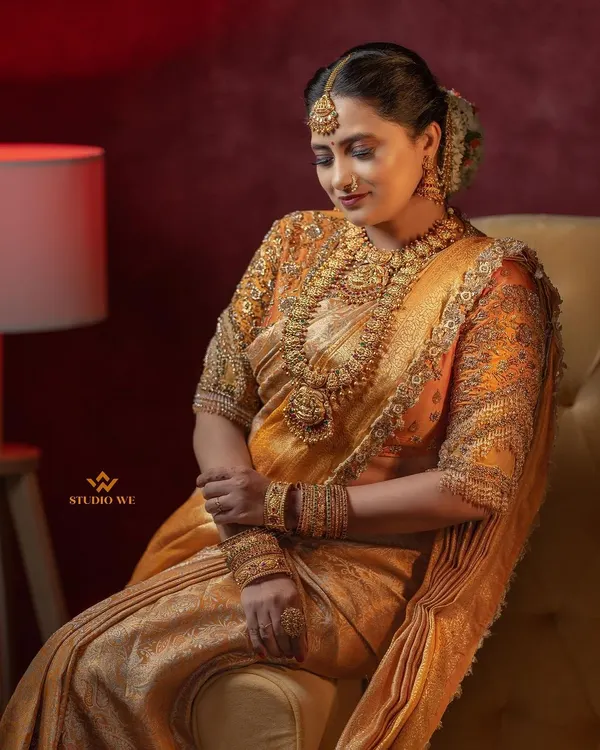 A stunning bridal portrait showcasing the bride's elegance and poise. The warm lighting and classic pose create a timeless and sophisticated image.