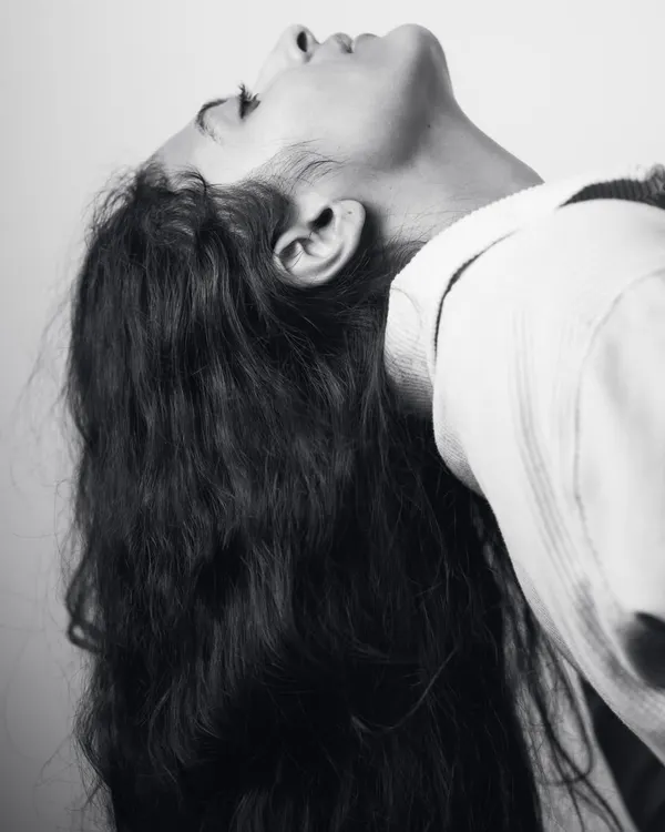 An expressive pose from my boudoir series, focusing on the curve of the neck and flow of my hair. This shot is about capturing emotion through body language in a simple, artistic way.