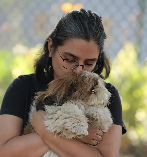 A guest at our dog party shares a tender moment with her Shih Tzu. Our events are designed to be safe spaces where pets and their parents can relax and enjoy each other's company.