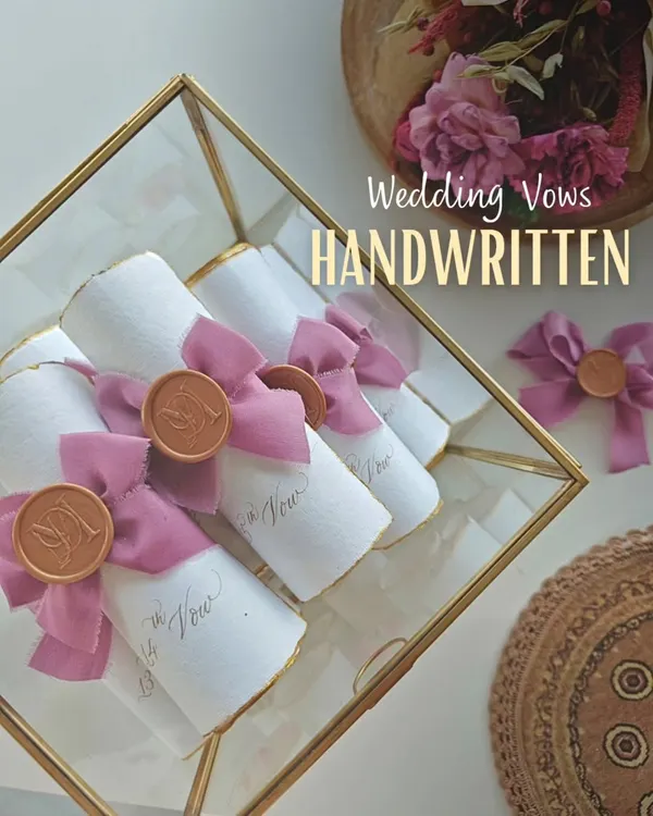 Your wedding vows, handwritten and preserved as timeless scrolls. Each one is finished with a silk ribbon and a custom wax seal, ready to be treasured long after your special day.