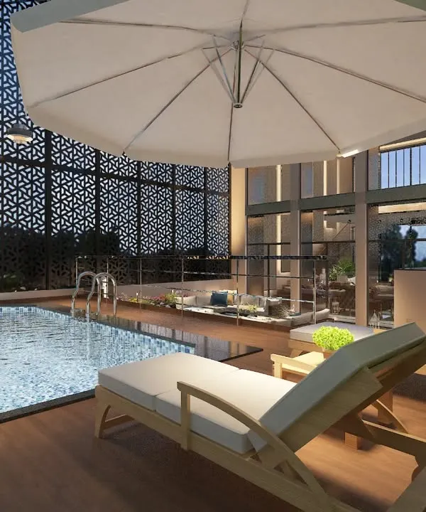 An evening view of the semi-enclosed rooftop pool at the Tata Executive Floor, featuring decorative screens for privacy and ambient lighting.