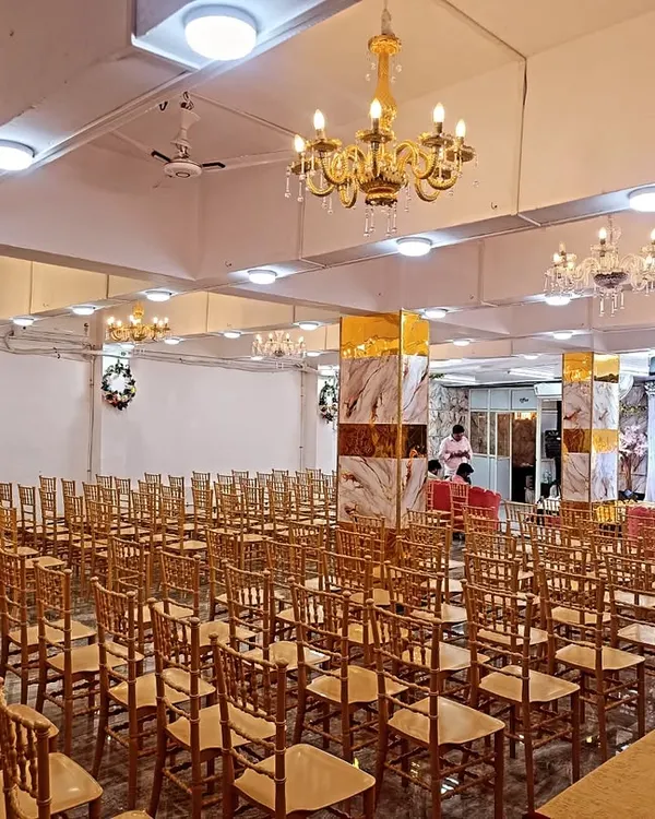 A wide view of our Kalyan West banquet hall, set up for a large gathering. You can see the spacious layout, the elegant pillars, and the ample seating we can provide.