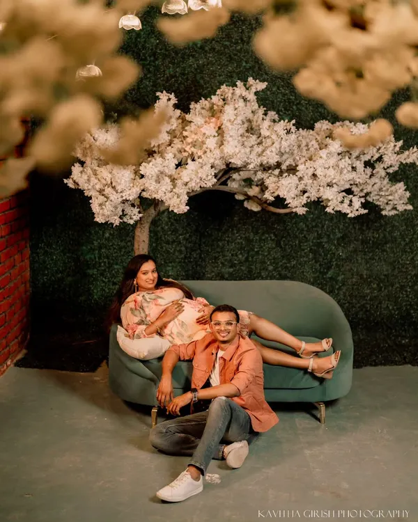 A dreamy studio setup for an expecting couple. The soft clouds and blossom tree create a serene, romantic atmosphere, perfect for capturing the magic of waiting for your baby together.