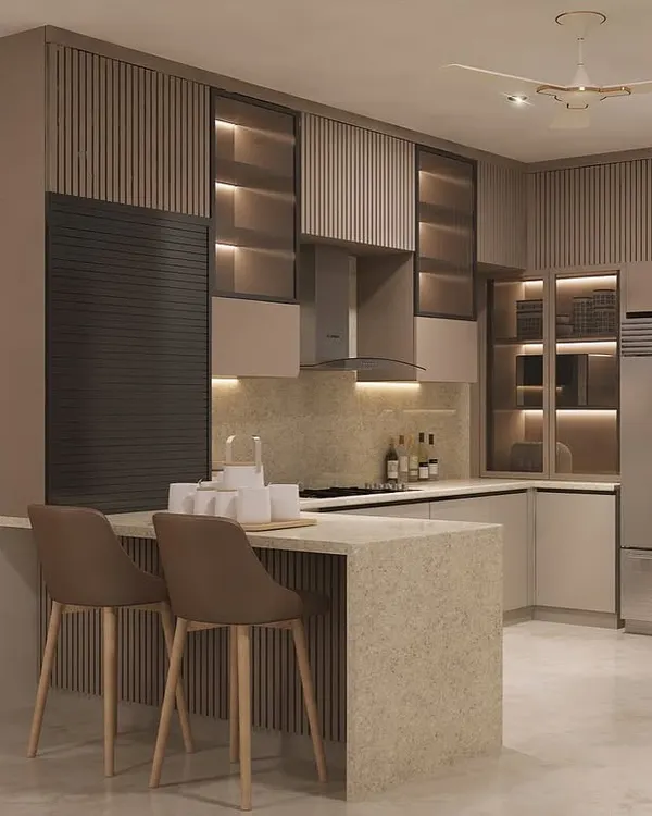 This kitchen design balances warm, earthy tones with modern functionality. We included a spacious breakfast island for casual dining, while the glass cabinets with internal lighting beautifully display crockery and add depth to the space.